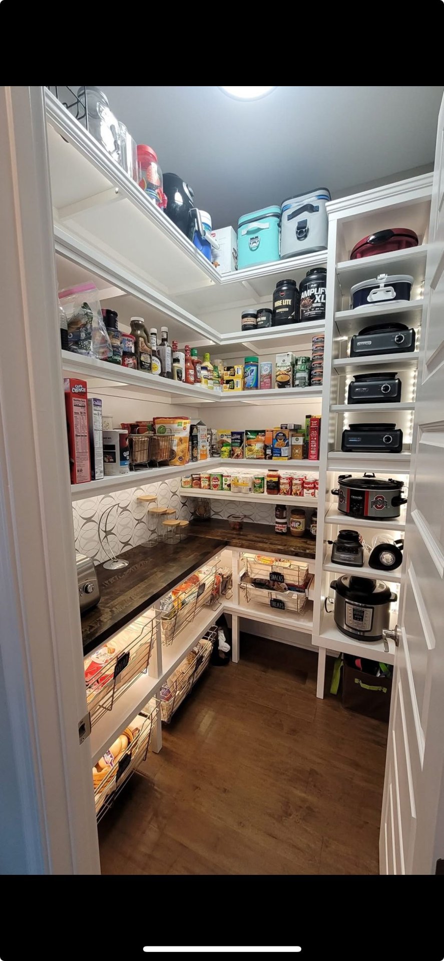 Organized Walk-In Pantry With Custom Shelving and Appliance Storage