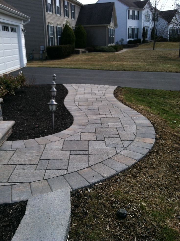 Curved Concrete Paver Walkway Leading to Suburban Home Entrance