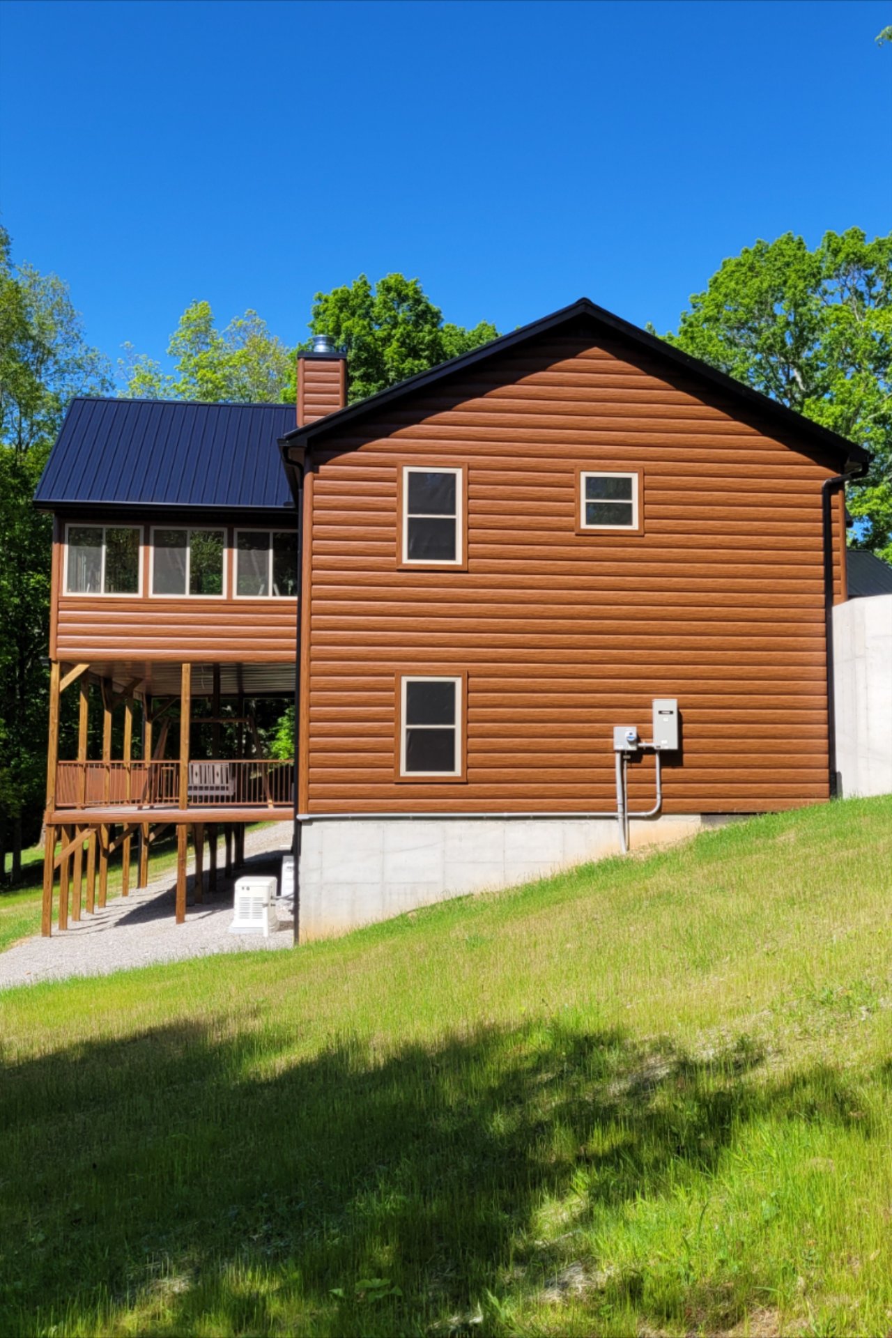 Modern Cabin-Style Home Exterior with Wood Siding and Metal Roof