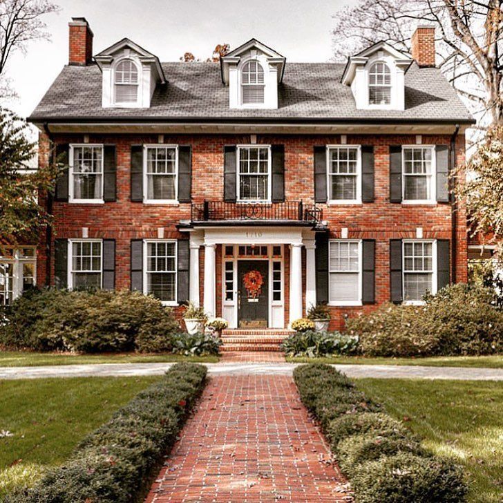 Classic Red Brick Colonial Home with Symmetrical Facade and Dormer Windows