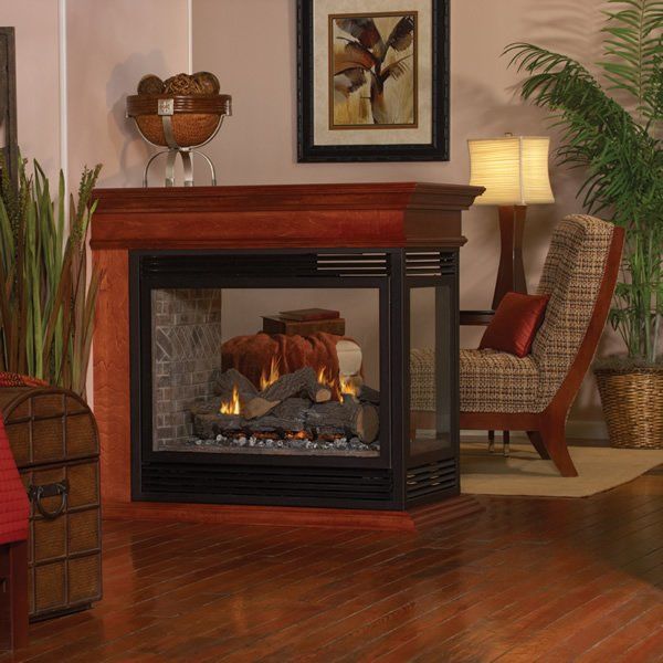 Three-Sided Glass Fireplace with Wood Mantel in Cozy Living Room Corner